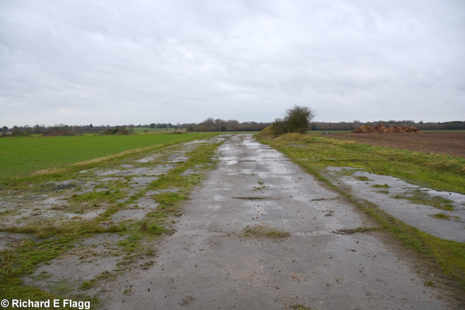 011Taxiway at the south of the airfield. Looking south west from the road at Bush Green - 12 December 2015.png